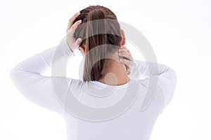 A woman feeling exhausted and suffering from neck and head pain and injury on isolated white background. Health care and medical