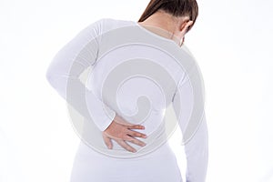 A woman feeling exhausted and suffering from waist and back pain and injury on isolated white background. Health care and medical