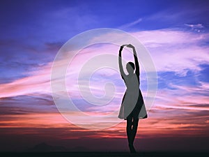 Woman feeling free at sunset