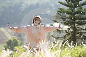 Woman feeling freedom standing in natural grass field