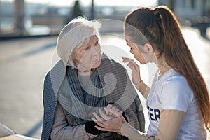 Woman feeling grateful while speaking with volunteer