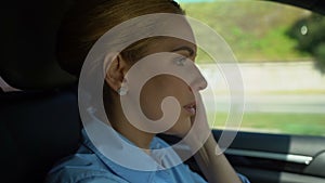 Woman feeling headache while driving, migraine symtoms, close-up of female