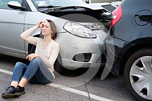 Woman feeling pain and whiplash after cars pileup