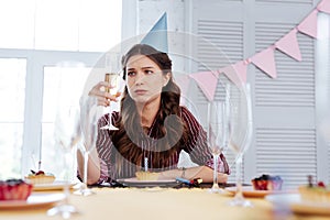 Woman feeling pessimistic at birthday party