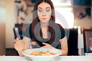 Woman Feeling Sick While Eating Bad Food in a Restaurant