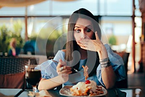 Woman Feeling Sick While Eating Huge Meal photo