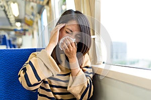 Woman feeling sick inside train compartment