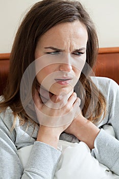 Woman feeling sore throat