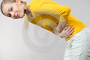 Woman feeling stomach cramps holding her belly