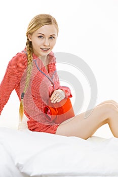 Woman feeling stomach cramps lying on bed