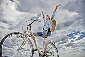 Woman feels happy while enjoy cycling. Girl rides bicycle sky background. How cycling changes your life and make you