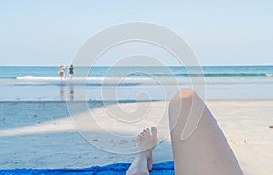 Woman feet closeup of girl relaxing on beach