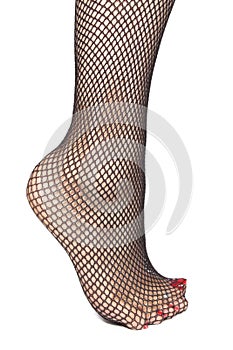 Woman feet with fishnet tights over white