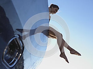 Woman with Feet Hanging from Boat