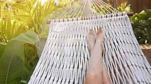 Woman feet lay down in net hammock
