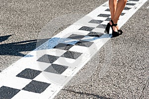 Woman feet on motorsport asphalt track