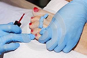 Woman feet receiving pedicure. Close up concept.