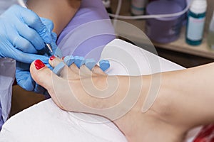 Woman feet receiving pedicure. Close up concept.