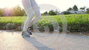 Woman feet running in the park.