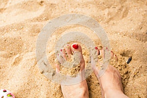 Woman feet on the sand