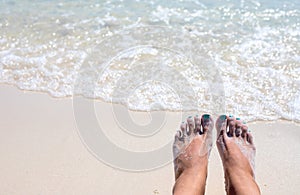 Woman feet on sunny sea beach. Relaxed barefoot tourist by sea. Seaside banner template. Sea water tide