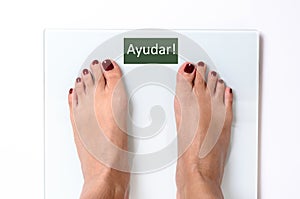 Woman feet on weight scales photo