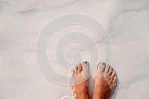 Woman feet and white sand texture. Relaxed tourist on beach. Tropical vacation banner template with text place