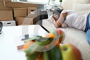 Woman fell asleep from fatigue while folding boxes