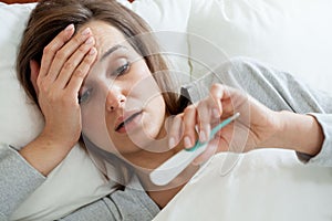 Woman with fever in bed