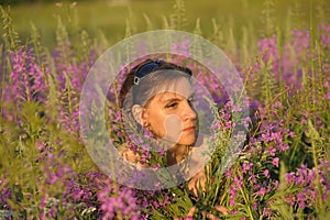 Woman in a field with flowers EpilÃ³bium angustifolium
