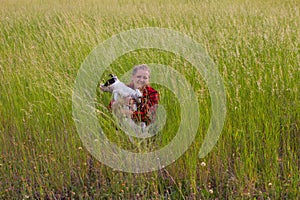 a woman in a field with her beloved pet on a walk.