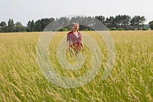 a woman in a field with her beloved pet on a walk.