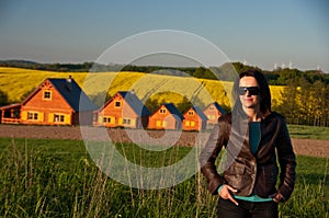 Woman in field by houses