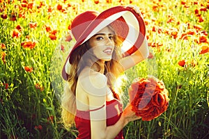 Woman in field of poppy seed in retro hat