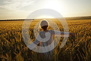 Woman in a field of ripe wheat