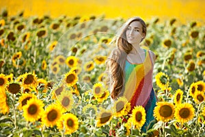 Woman in the field among sunflowers.