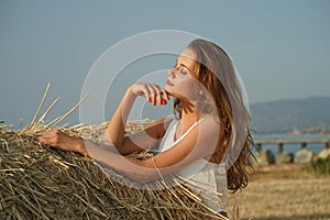Woman in field by the sunset
