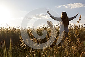 Woman in field on sunset