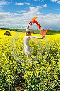 Woman in fields of golden canola