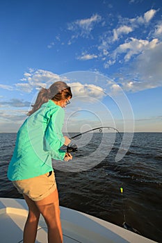 Woman Fighting Fish Saltwater Fishing With Rod and Reel