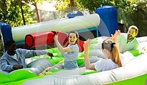 Woman fighting off friends with inflatable beam