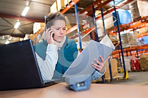 woman with file folder in front warehouse photo