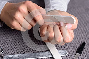 Woman filing her finger nails