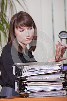 Woman filing her fingernails by work