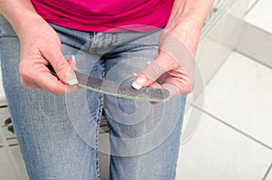 Woman filing her nails