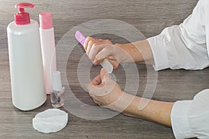 Woman filing and smoothing fingernails photo