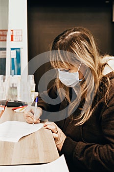 Woman filing social security benefits application form. Concept of Covid-19, world economic crisis, unemployment