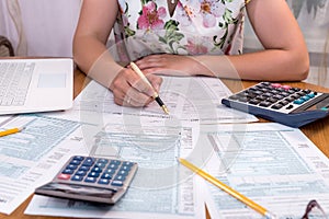 Woman filling 1040 individual tax form