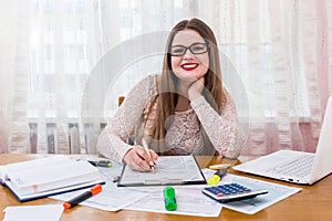 Woman filling 1040 individual tax form, office work