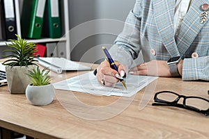 woman filling 1040 tax return form at office